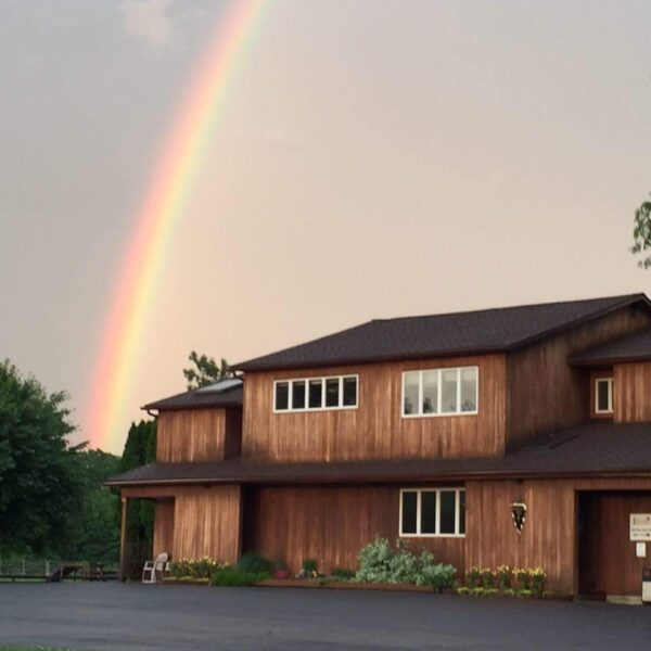 view of the front of otterkill animal hospital with a rainbow in the sky above it