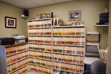 front desk area at otterkill animal hospital, including a desk and pet record files